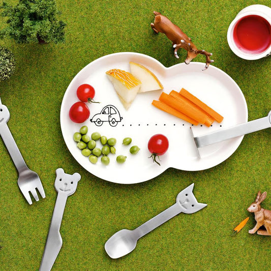 gense animal freinds collection Children's plate with fruits, vegetables, and cutlery on a grassy background