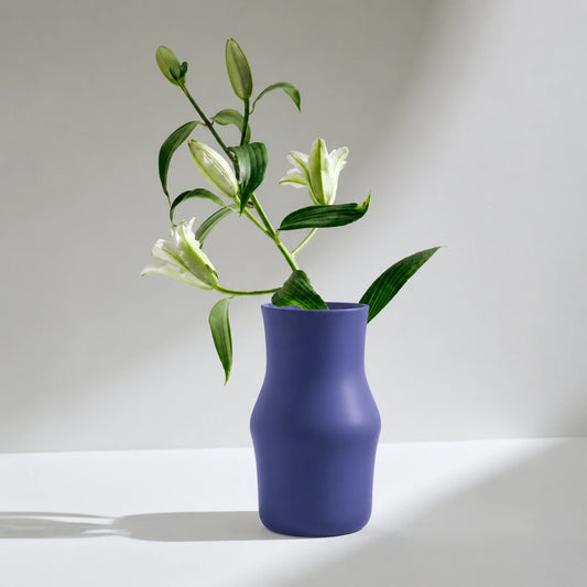 Dorotea Ceramic Blue vase with white flowers on a light gray background