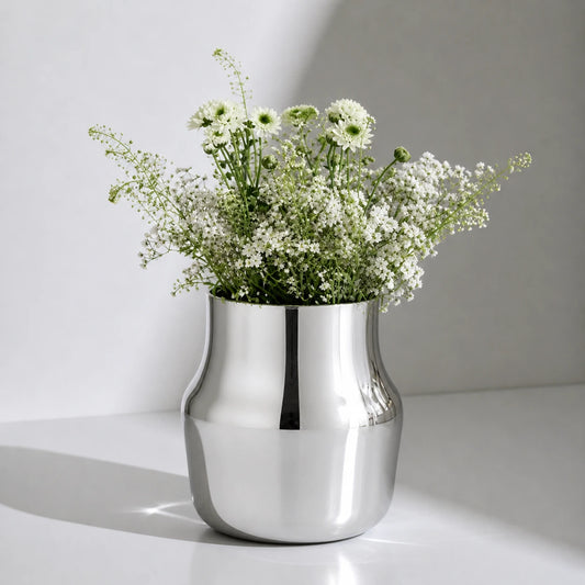 Dorotea Stainless steel vase with flowers on a white surface